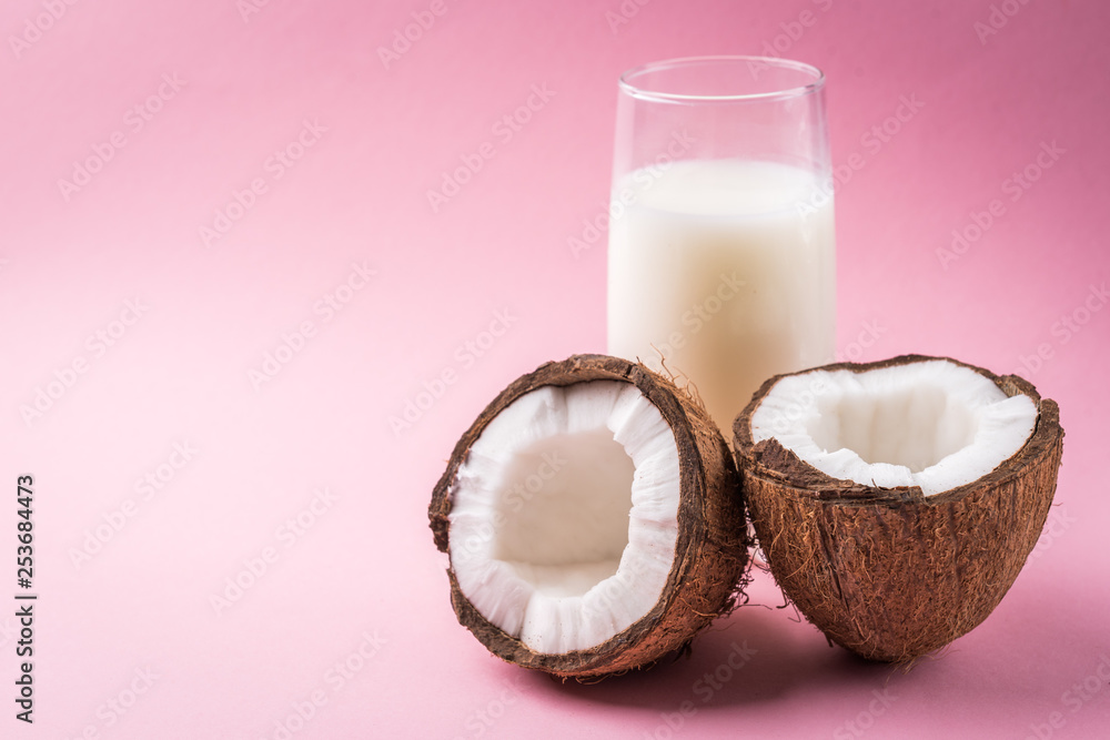 Coconut milk on pink background. Coconut milk on pink background.