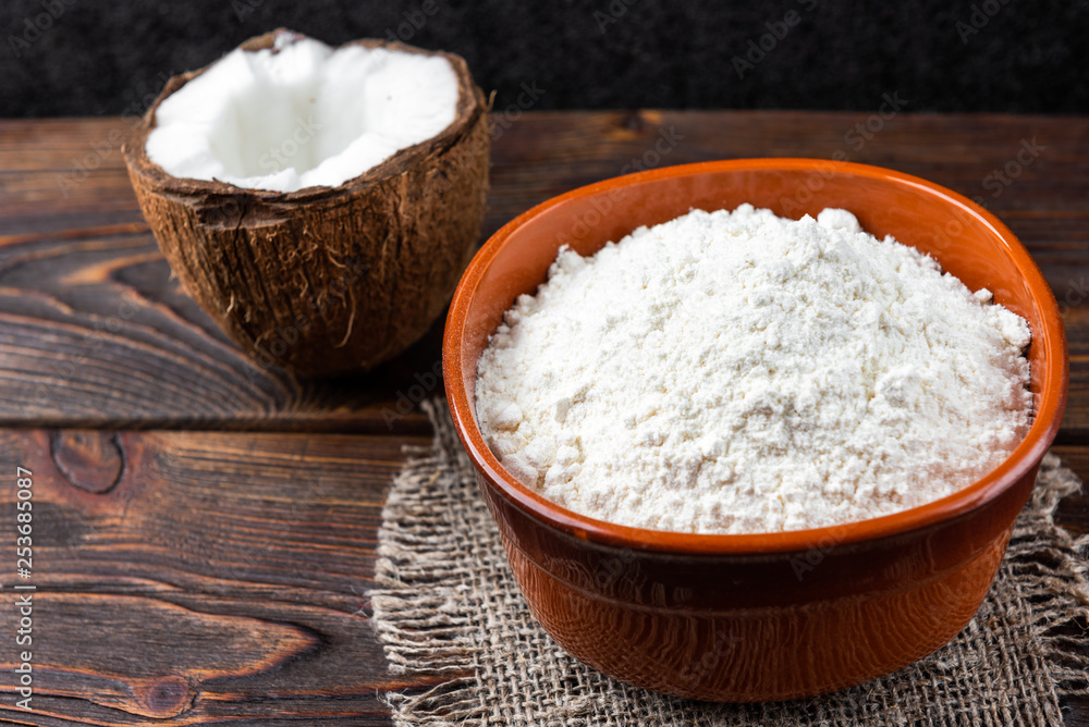 Coconut flour on dark wooden background. Coconut flour on dark wooden background.