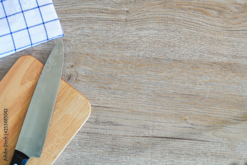 Chef's knife and Chopping board on wood table. photo