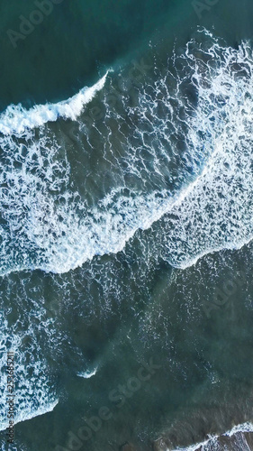 Aerial view of waves in beach of Sitges. Barcelona. Spain. Drone Photo