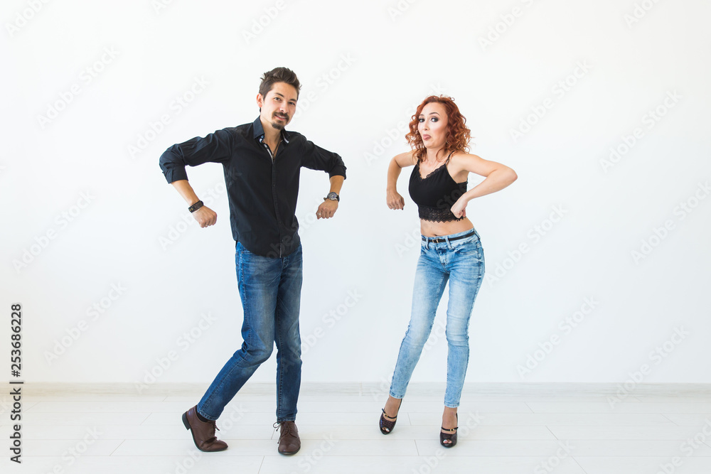 Social dance concept - Crazy dancing, cheerful couple over white background Social dance concept - Crazy dancing, cheerful couple over white background