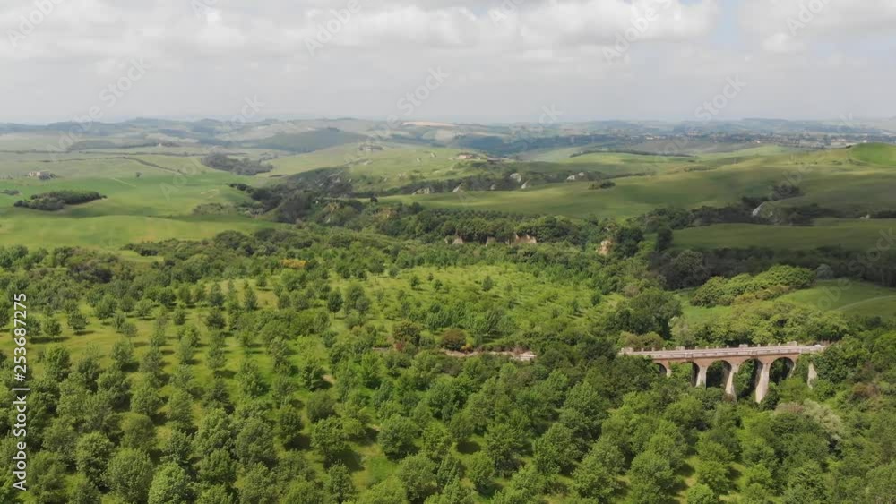Drone flight over a typical landscape of Siena in Tuscany, a countryside of Italy. Aerial view from the sky showing empty railway bridge in the distance Drone flight over a typical landscape of Siena in Tuscany, a countryside of Italy. Aerial view from the sky showing empty railway bridge in the distance