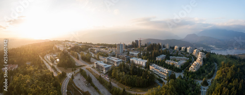 Aerial view of residential buildings on top of Burnaby Mountain during a vibrant sunset. Taken in Greater Vancouver, BC, Canada. © edb3_16