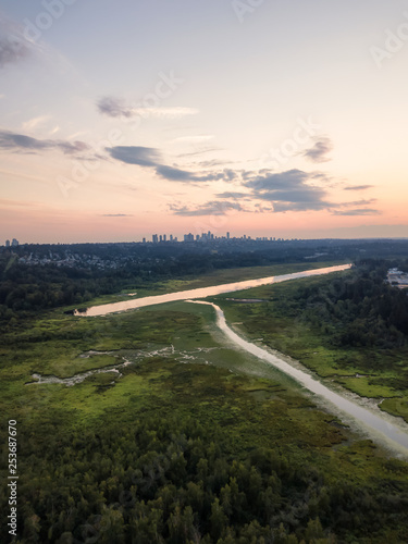 Aerial view of Burnaby Lake in the modern city during a vibrant summer sunset. Taken in Vancouver, BC, Canada.