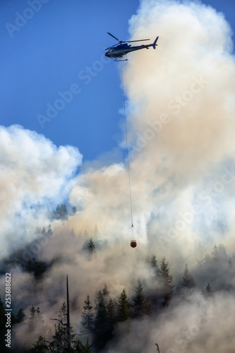 Helicopter fighting BC forest fires during a hot sunny summer day. Taken near Port Alice, Northern Vancouver Island, British Columbia, Canada. © edb3_16