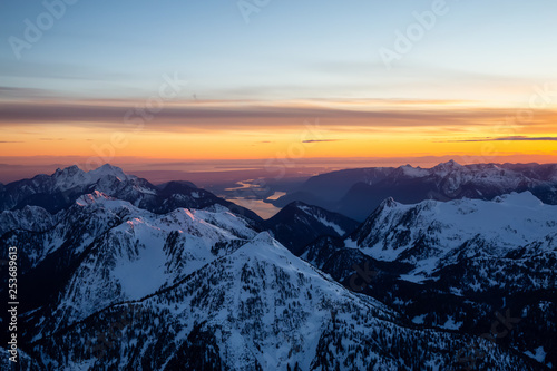 Aerial view of Canadian Mountain Landscape during a vibrant sunset. Taken North of Vancouver  British Columbia  Canada.