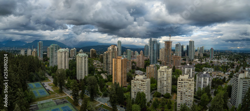 Aerial Panoramic view of residential homes in a modern city during a vibrant summer cloudy day. Taken in Burnaby, Vancouver, BC, Canada.