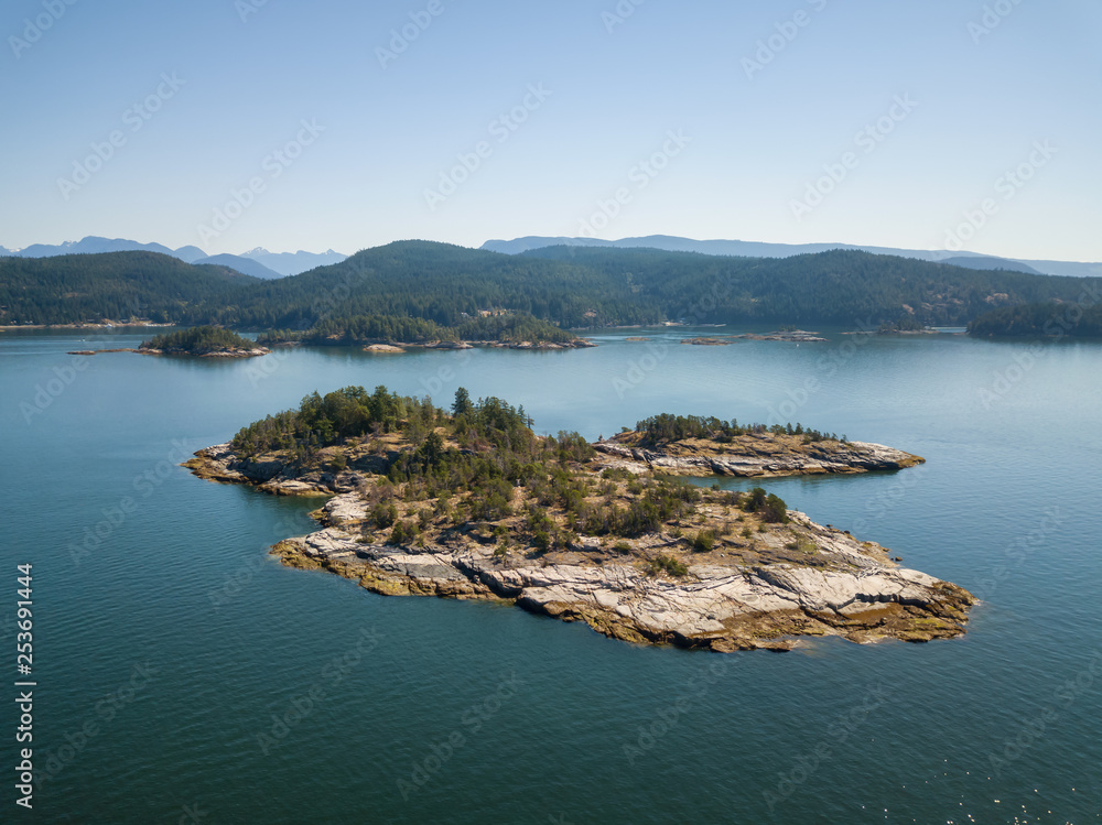 Aerial view of a rocky island during a vibrant sunny summer day. Taken near Powell River, Sunshine Coast, British Columbia, Canada.