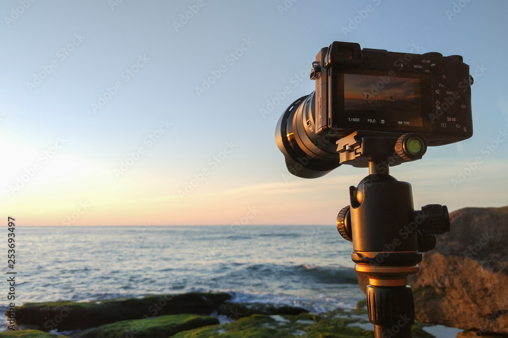 Mirrorless camera on a tripod by the sea