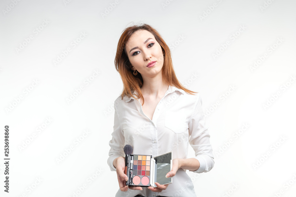 Beauty makeup artist. Close Up korean beautiful young woman pretty smiling holding eye shadow palette brush on white background