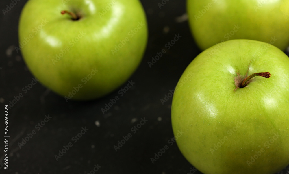 Close up photo, green apples on black board. Close up photo, green apples on black board.