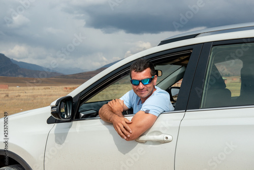 Man in vehicle, looking out of window