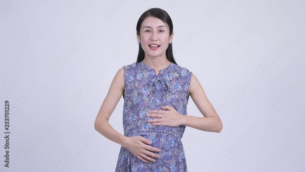 Happy pregnant Asian woman pointing at camera Happy pregnant Asian woman pointing at camera