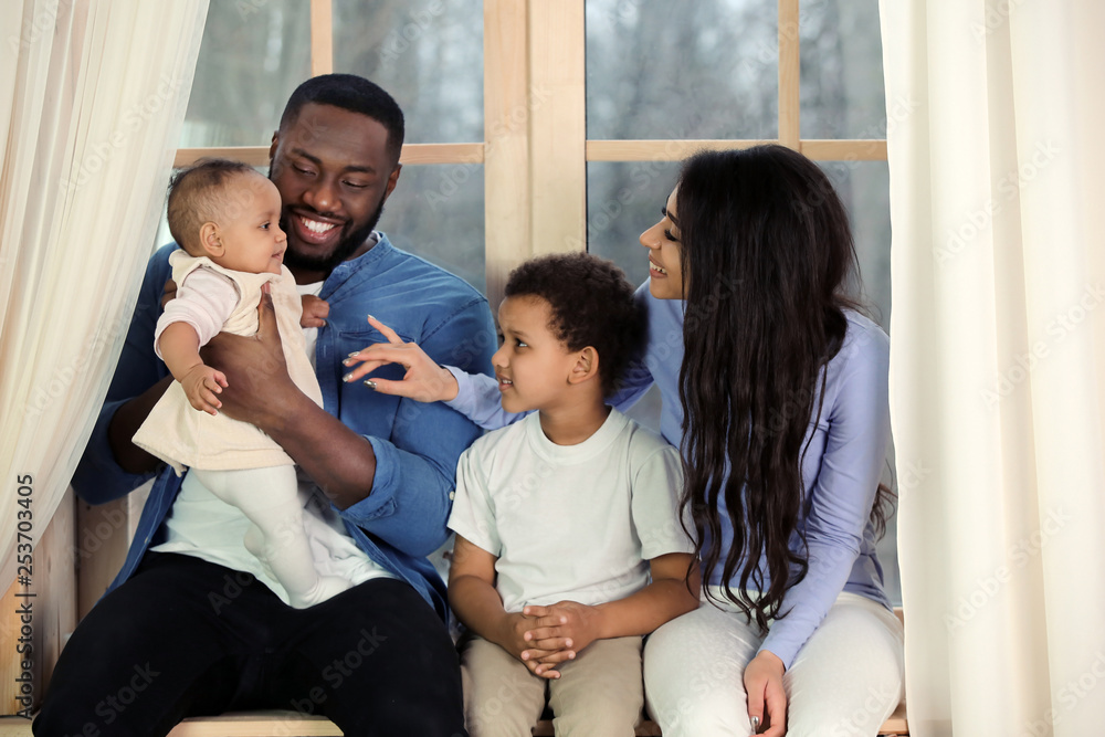 African-American couple with their children at home. Happy parents African-American couple with their children at home. Happy parents