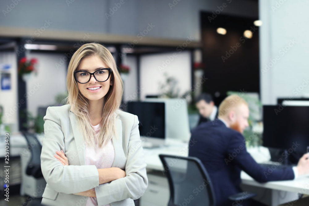 Fototapeta premium Young woman in modern office. Small business owner