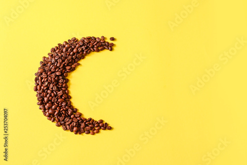 Roasted coffee grains lying in the shape of the moon from photo