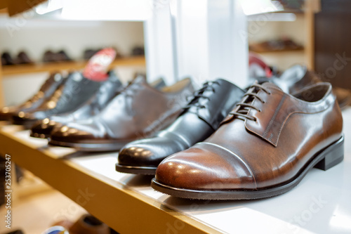 a row of leather brown men's shoes in the store
