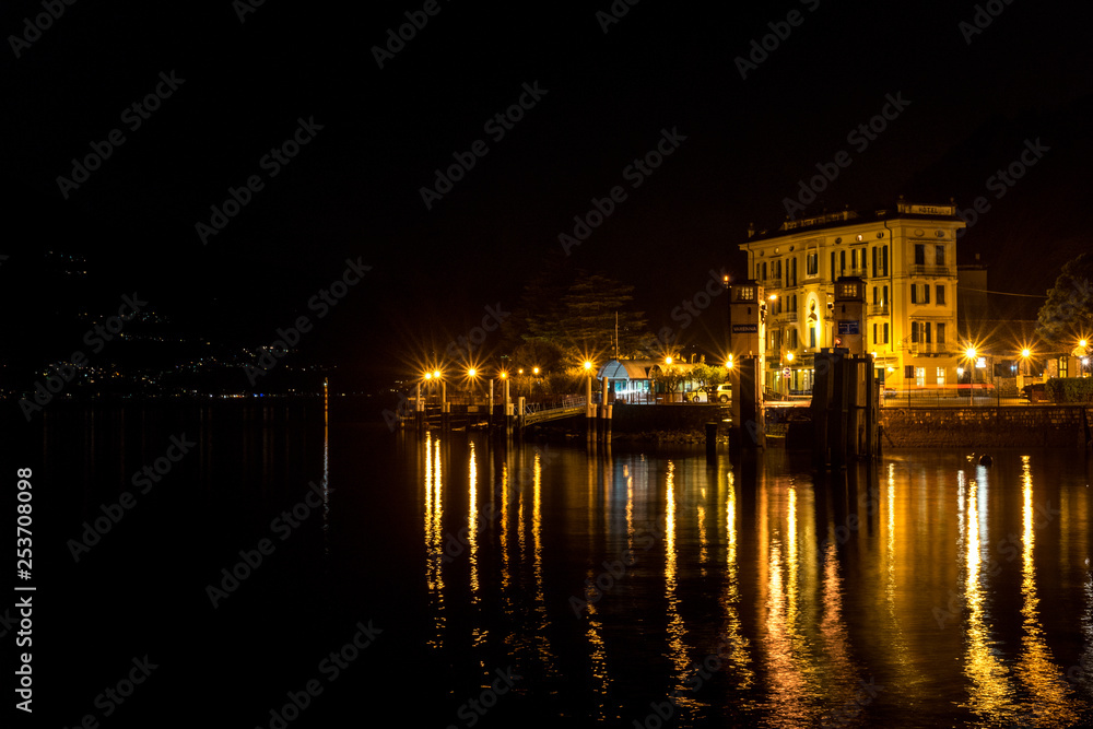 Italy, Varenna, Lake Como, a body of water with a city in the night sky