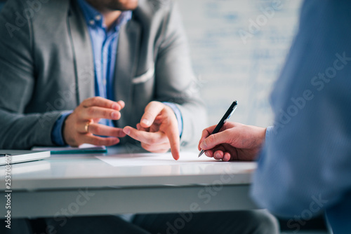 Business consultant and customer on a meeting in the office, signing contract. photo