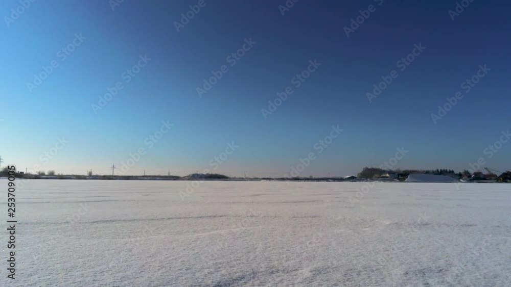 Fast flight over frosty field full of snow Fast flight over frosty field full of snow