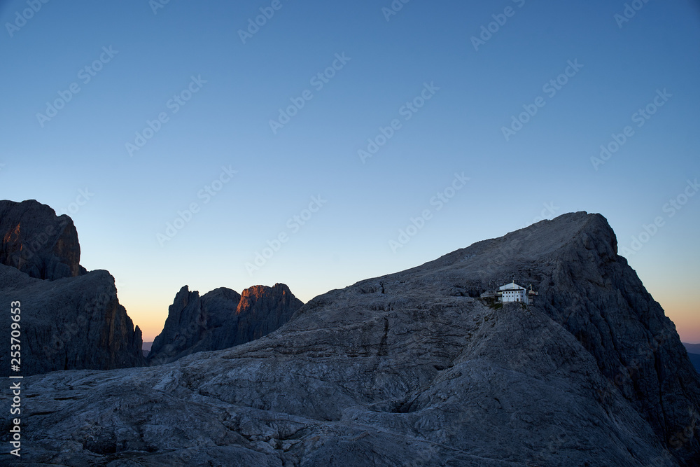 Obraz premium Rosetta peak with moon at sunrise, Pale di San Martino, Primiero, Italy