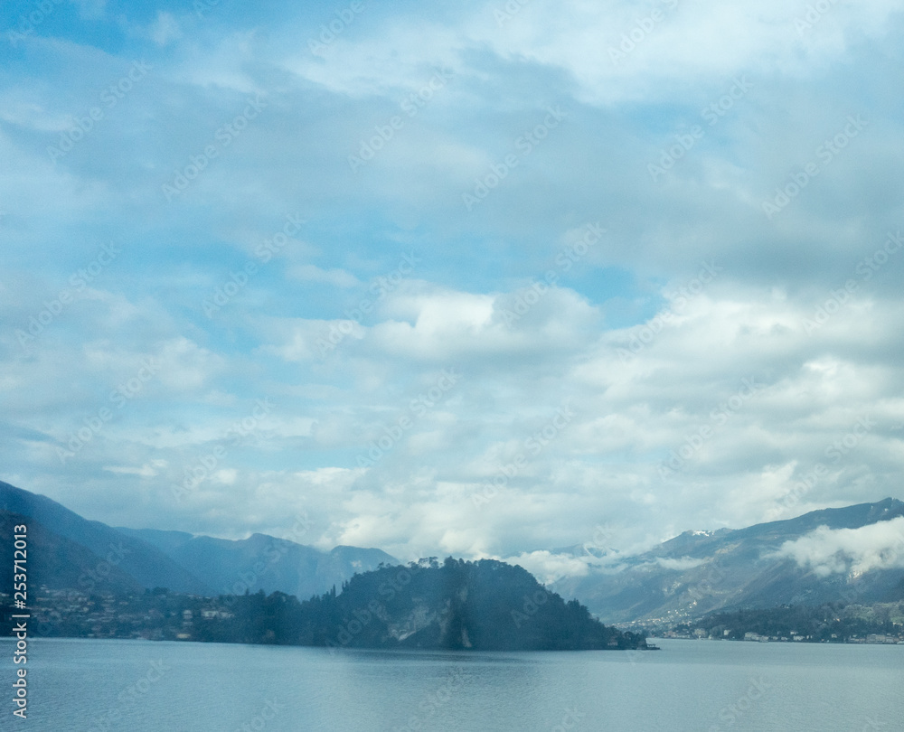 Obraz premium Italy, Varenna, Lake Como, a body of water with a mountain in the background
