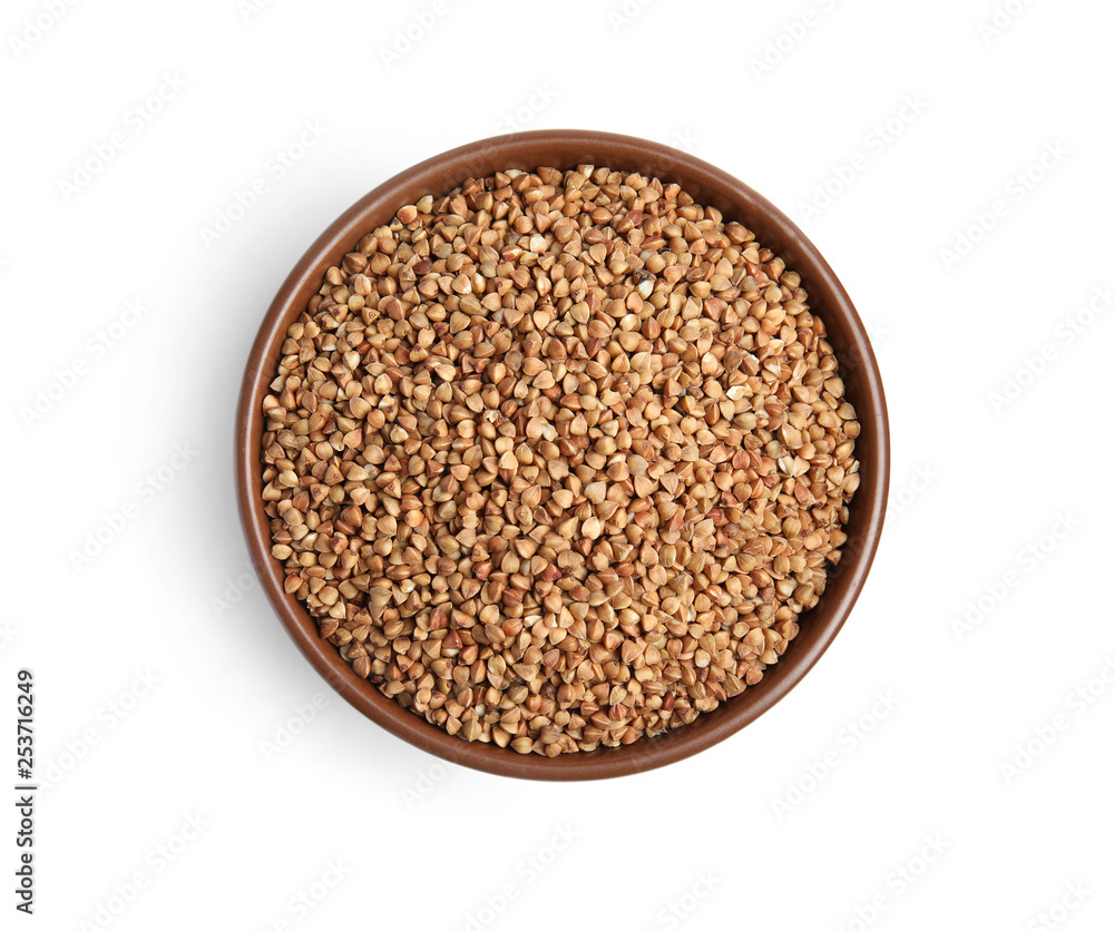 Bowl with uncooked buckwheat on white background, top view Bowl with uncooked buckwheat on white background, top view