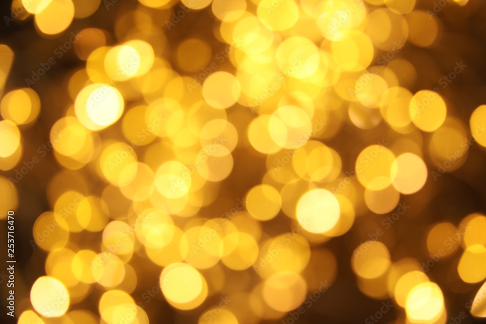 Gold glitter with bokeh effect on dark background Gold glitter with bokeh effect on dark background