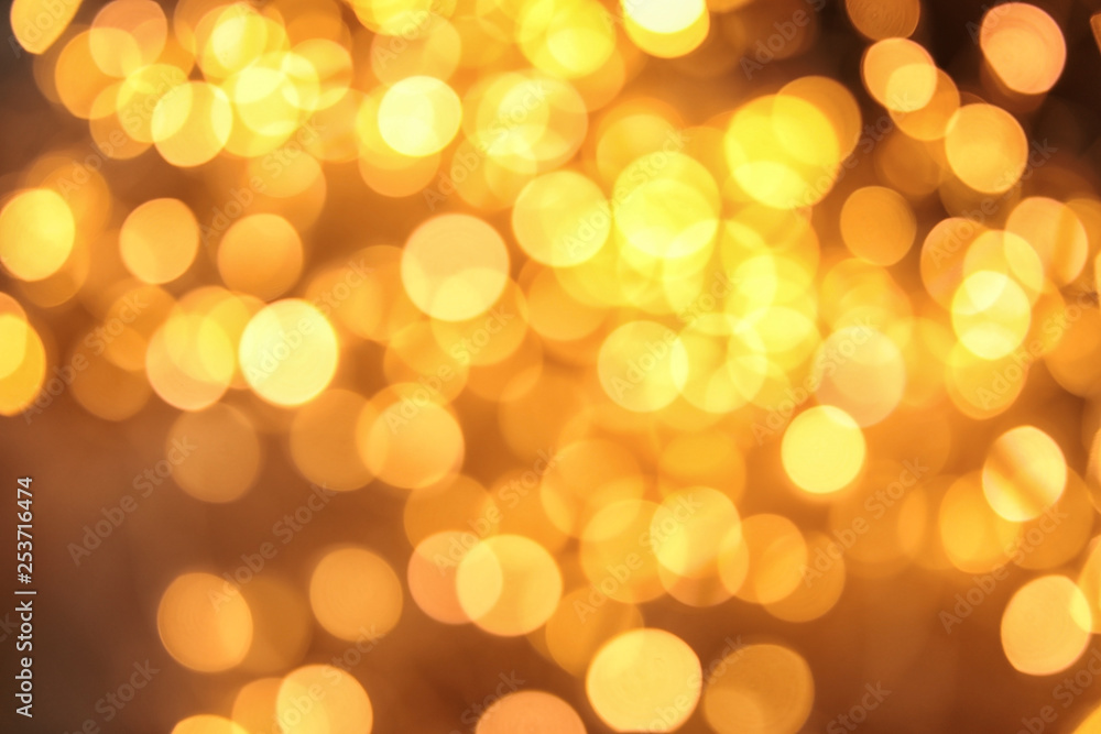 Gold glitter with bokeh effect on dark background Gold glitter with bokeh effect on dark background