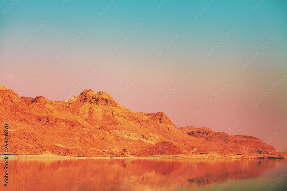 Mountainous coast of the Dead Sea in the evening at sunset