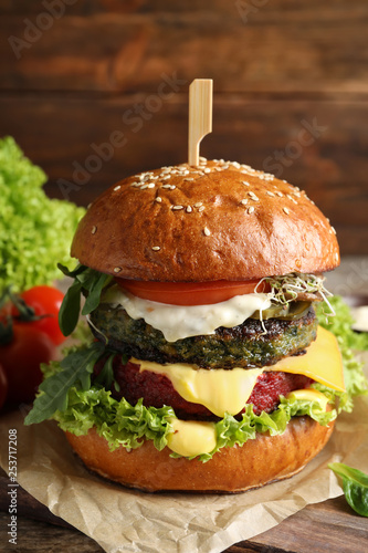 Vegan burger with beet and falafel patties on table