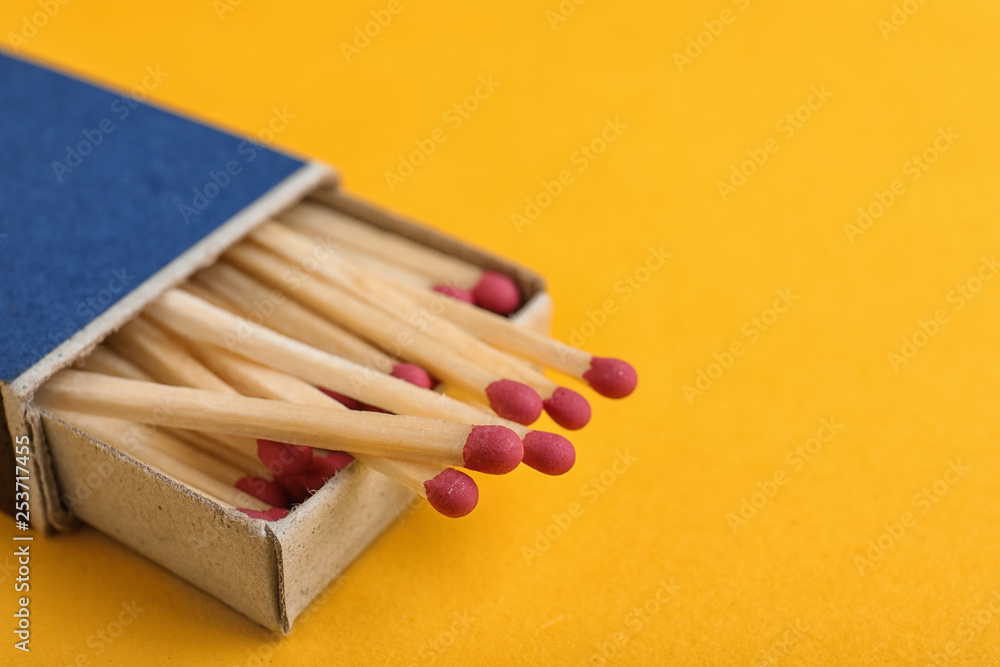 Cardboard box with matches on color background, closeup. Space for text Cardboard box with matches on color background, closeup. Space for text