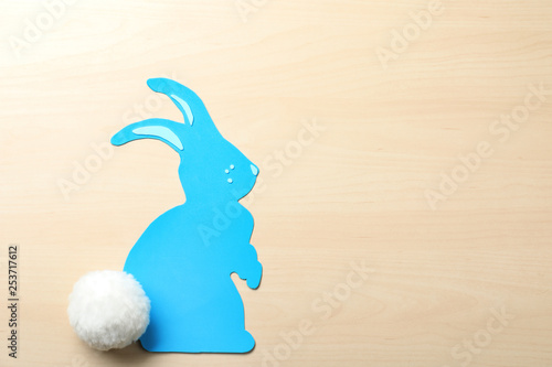 Flat lay composition of paper Easter bunny on wooden background, space for text