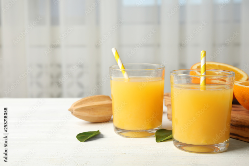 Composition with orange juice and fresh fruit on table, space for text Composition with orange juice and fresh fruit on table, space for text