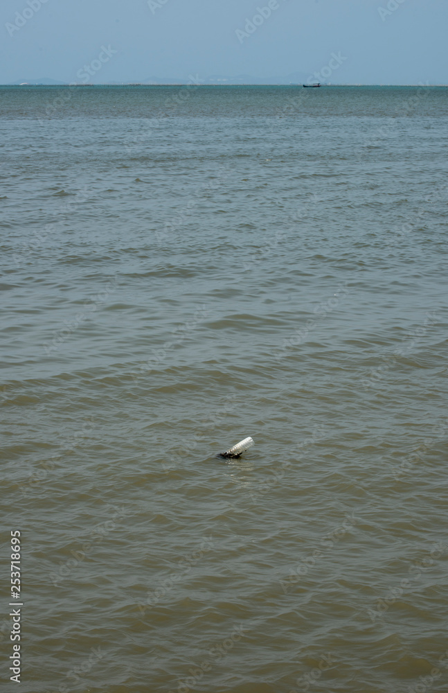 Plastic bottle found stuck in the sea near the beach. A starting point of the environment problem. Plastic bottle found stuck in the sea near the beach. A starting point of the environment problem.