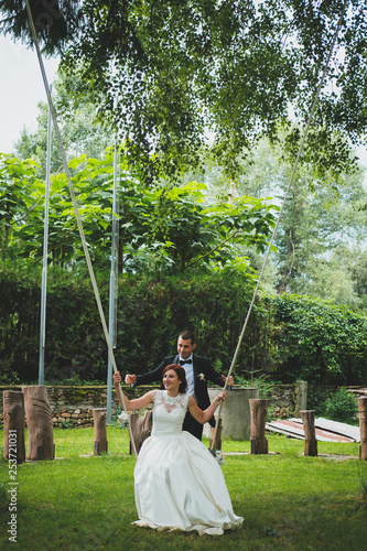 Bride and groom on a swing