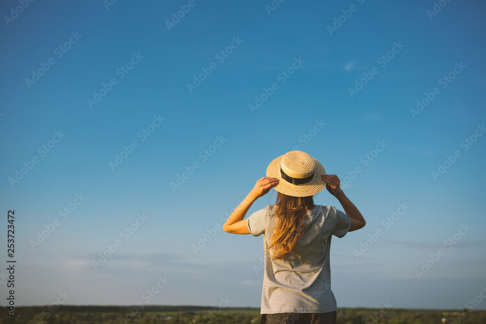 Blue sky and woman in hat