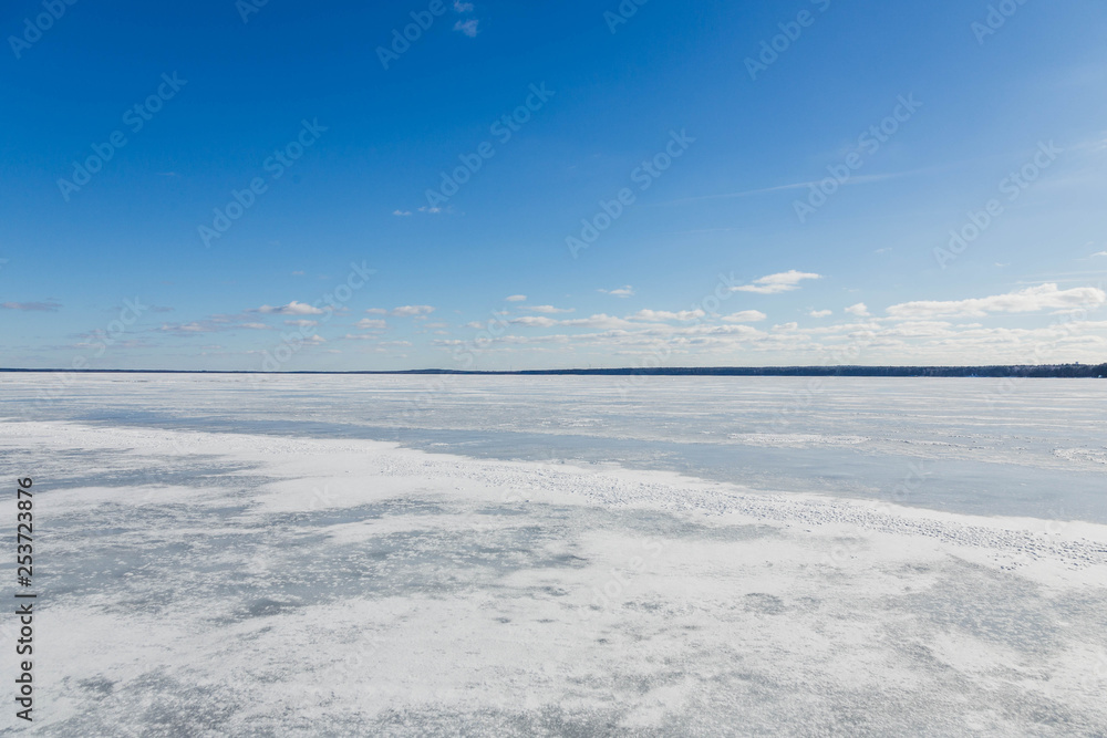 Winter landscape with frozen lake in clear weather Winter landscape with frozen lake in clear weather