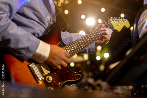 Guitarist play music in the night time.