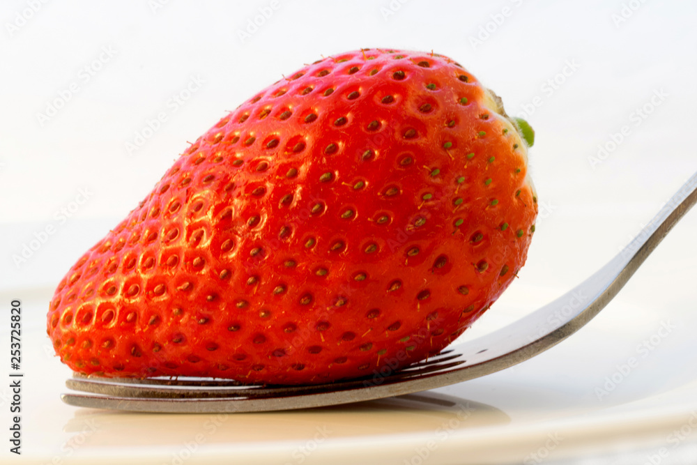 Strawberry with fork isolated on white background Strawberry with fork isolated on white background