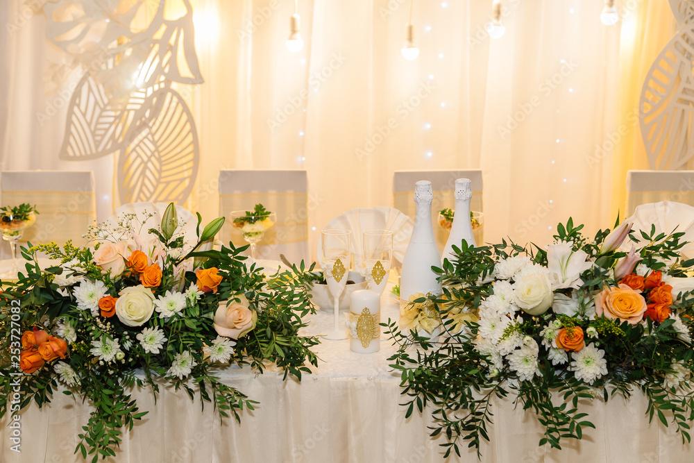 Wedding decor. Table for the newlyweds outdoor. Wedding reception. Elegant wedding table arrangement, floral decoration, restaurant. Wedding in the forest.