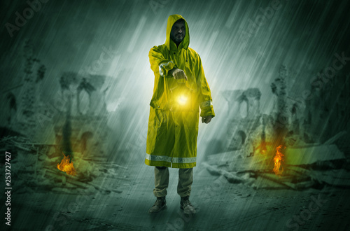 Destroyed place after a catastrophe with man in raincoat and lantern concept 