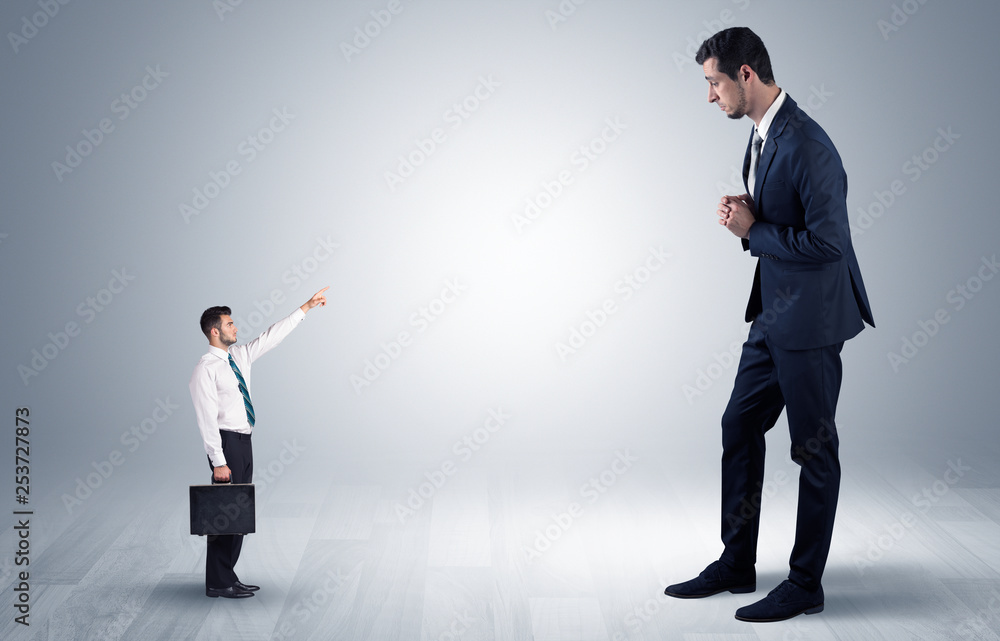 Small businessman in shirt pointing to an afraid businessman
Small businessman in shirt pointing to an afraid businessman