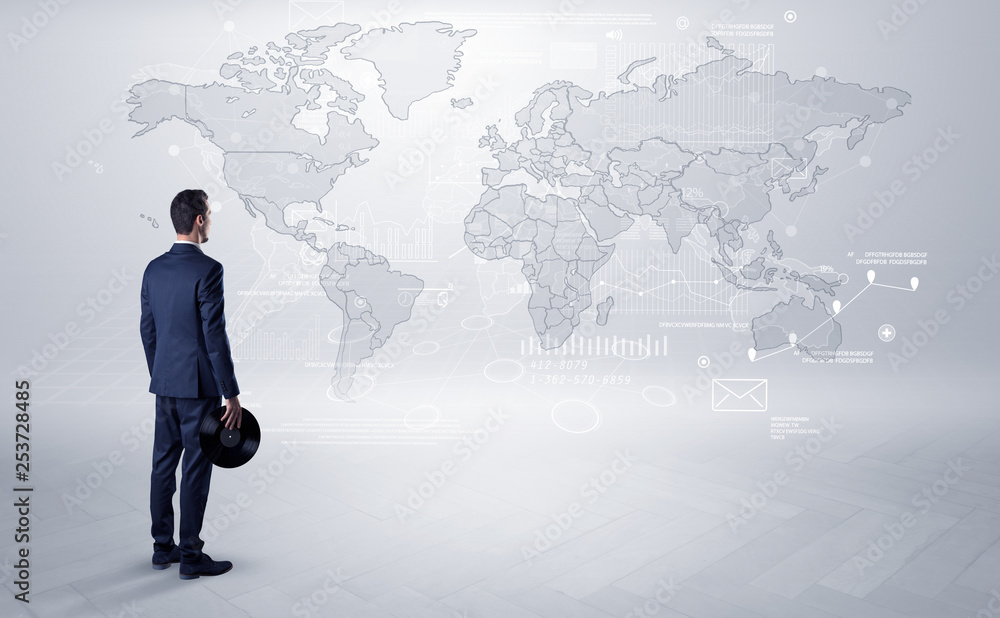 Businessman standing with his back and looking at a worldwide map with objects in his hand
Businessman standing with his back and looking at a worldwide map with objects in his hand