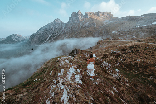 Woman in a dress with mountains in the background