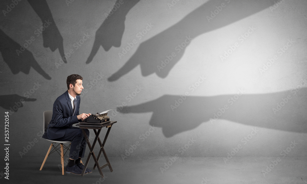 Shadow hand pointing at a small afraid worker
Shadow hand pointing at a small afraid worker