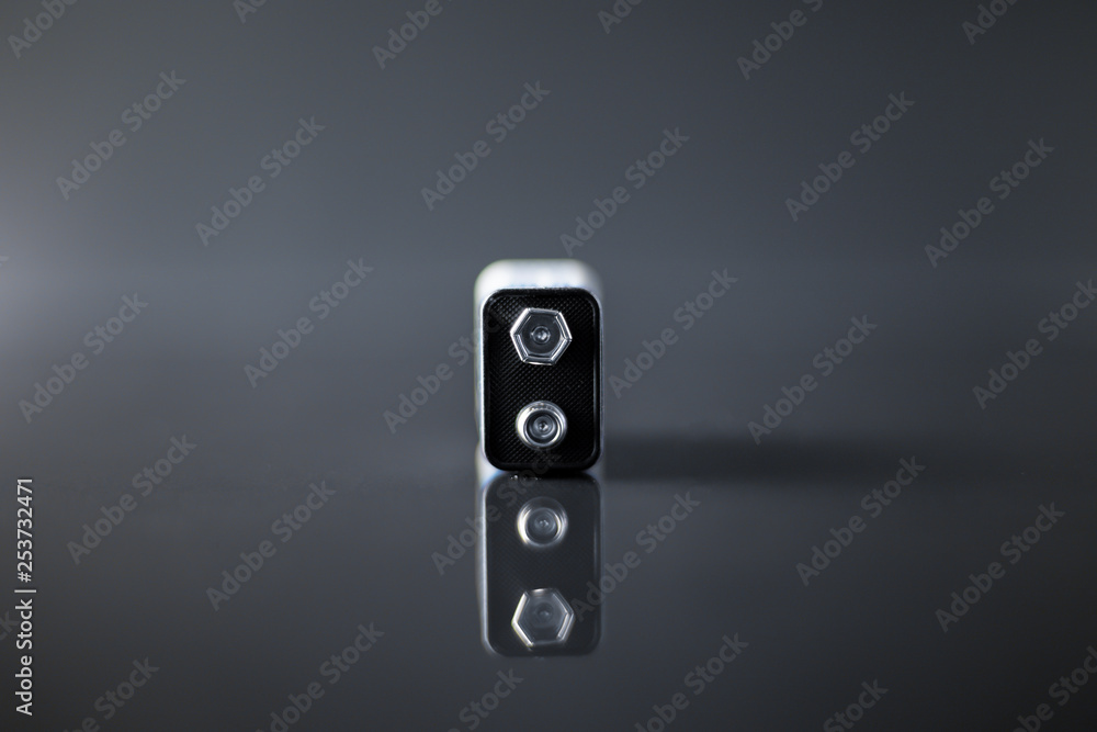 Battery on a black background with reflection on glass Battery on a black background with reflection on glass