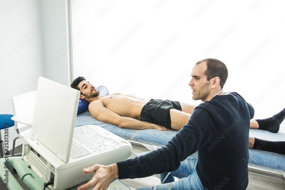 Physiotherapist examining a patient with an ultrasound scan. Physiotherapy and Rehabilitation