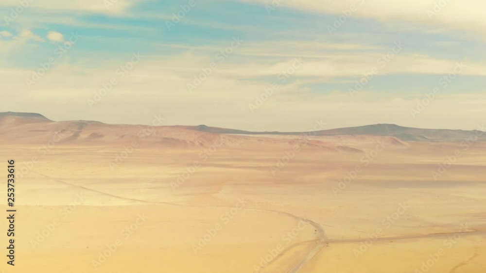 A road in the desert. Aerial view of Paracas National Park near Paracas town, Pisco Region, Peru. A road in the desert. Aerial view of Paracas National Park near Paracas town, Pisco Region, Peru.
