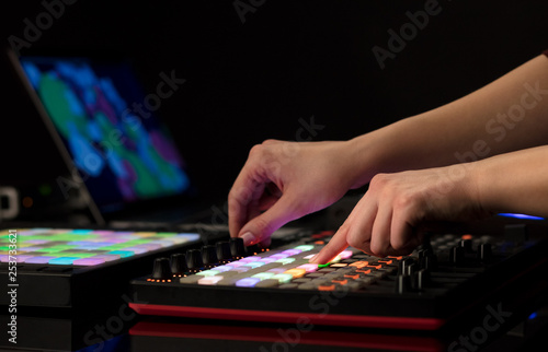 Dj hand remixing music on midi controller 